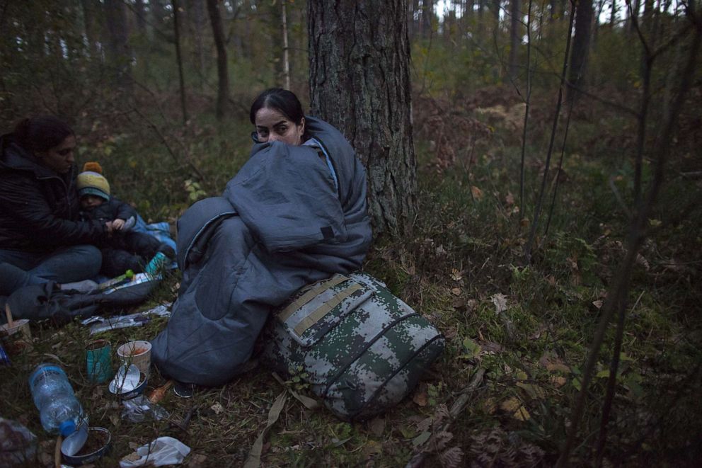 PHOTO: Migrants rest in sleeping bags after crossing Polish-Belarusian border near Michalowo, Oct. 6, 2021.