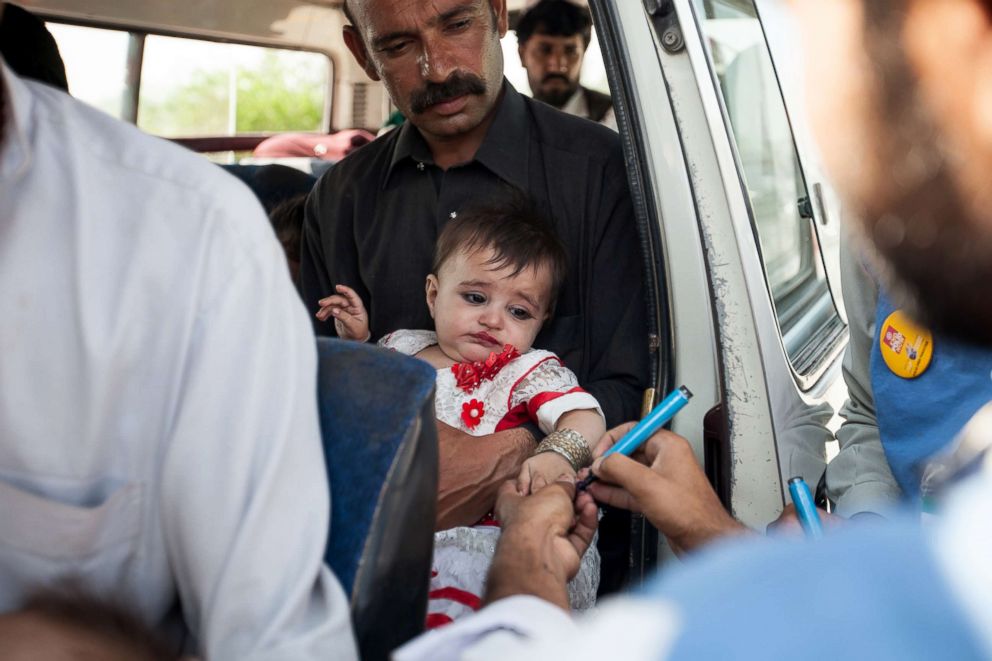 PHOTO: A team works at a polio-vaccine transit post at a checkpoint in northwest Pakistan.