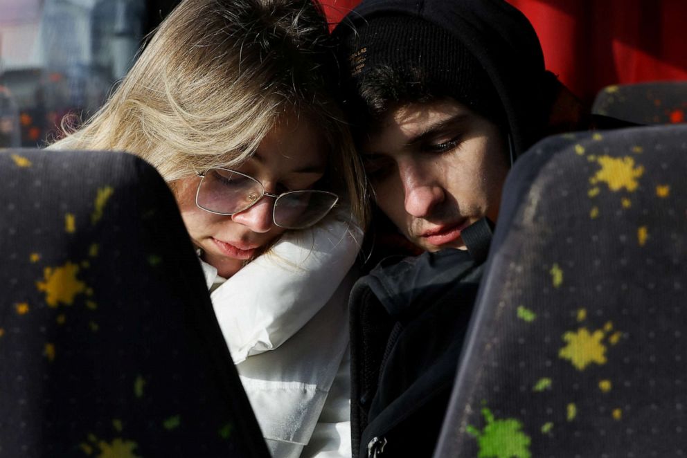 PHOTO: People sit on a bus as they arrive at the border crossing between Poland and Ukraine, after Russia launched a massive military operation against Ukraine, in Medyka, Poland, Friday, Feb. 25, 2022.