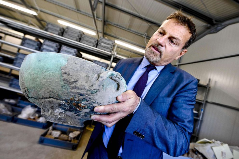 PHOTO: Massimo Osanna, Superintendent of the Special Superintendency for the archaeological heritage of Pompeii, Herculaneum and Stabia shows a bronze vase discovered during excavation works at the archaeological site of Pompeii, Italy, May 17, 2018.
