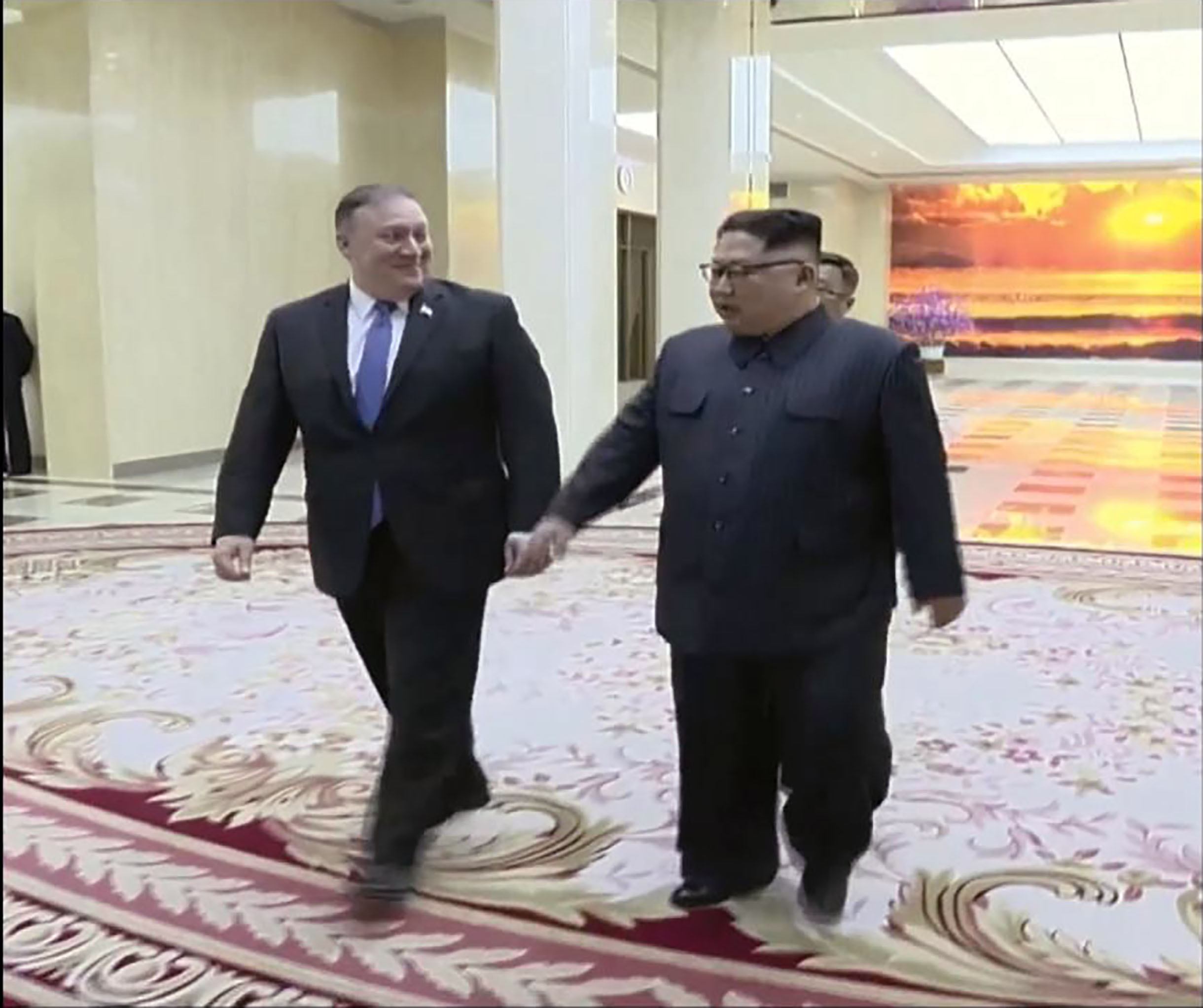 PHOTO: A scene shown on North Korean state TV of U.S. Secretary of State Mike Pompeo walking with North Korean President Kim Jong Un, May 9, 2018.