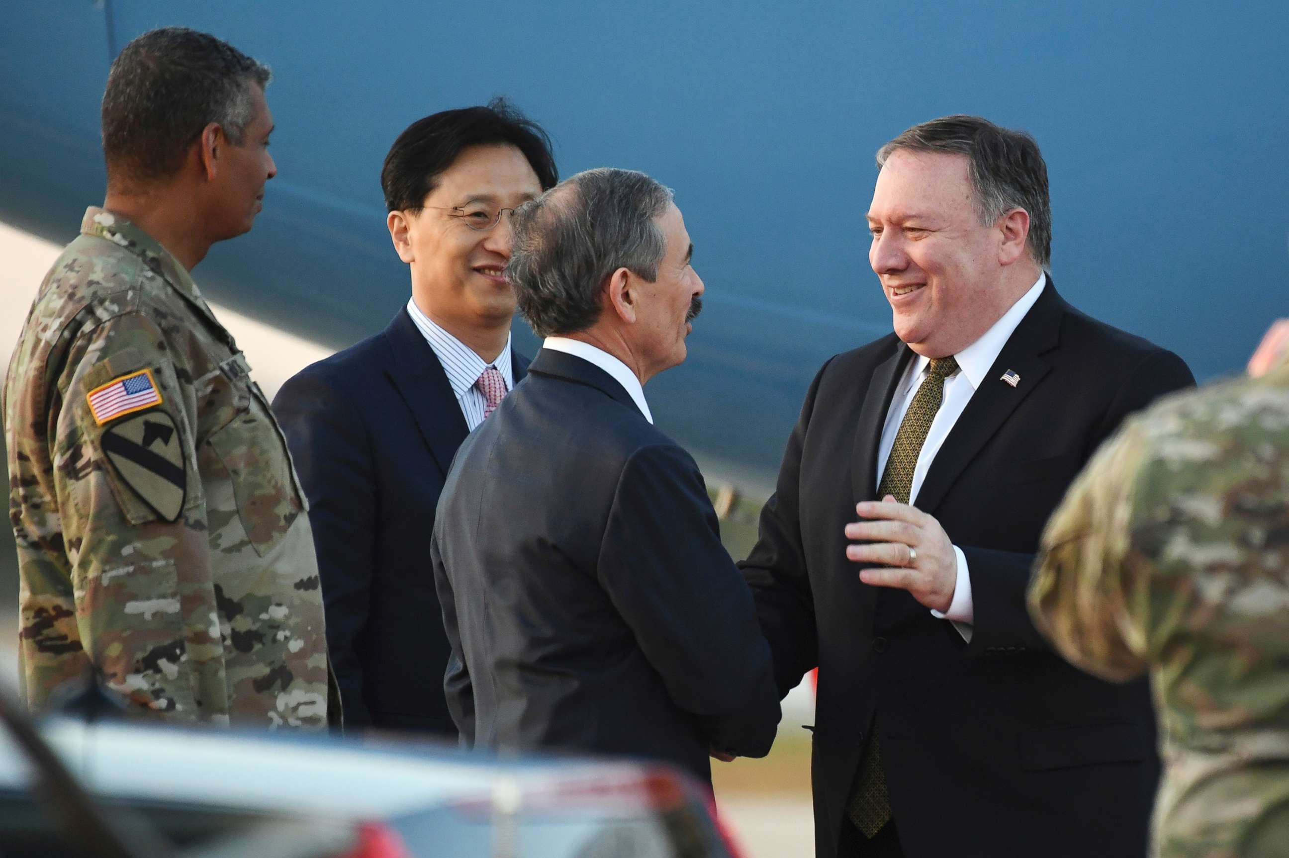 PHOTO: Secretary of State Mike Pompeo, right, is greeted by U.S. Ambassador to South Korea Harry Harris upon his arrival at Osan Air Base in Pyeongtaek, in South Korea, Oct. 7, 2018.
