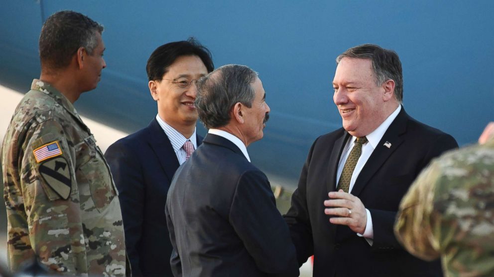 PHOTO: Secretary of State Mike Pompeo, right, is greeted by U.S. Ambassador to South Korea Harry Harris upon his arrival at Osan Air Base in Pyeongtaek, in South Korea, Oct. 7, 2018.