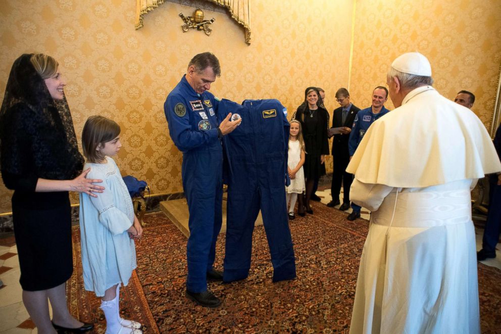 PHOTO: Pope Francis receives an astronaut suit from Italian astronaut Paolo Nespoli during a private meeting with crew members of the ISS 53 space mission at the Vatican, June 8, 2018.