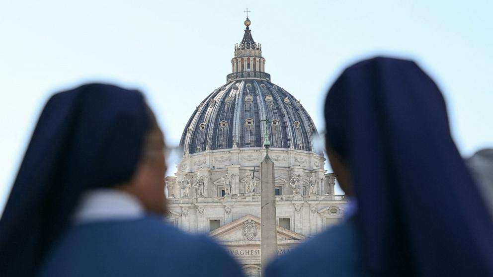 PHOTO: Two nuns stand in front of St Peter's basilica at the Vatican, April 22, 2025.