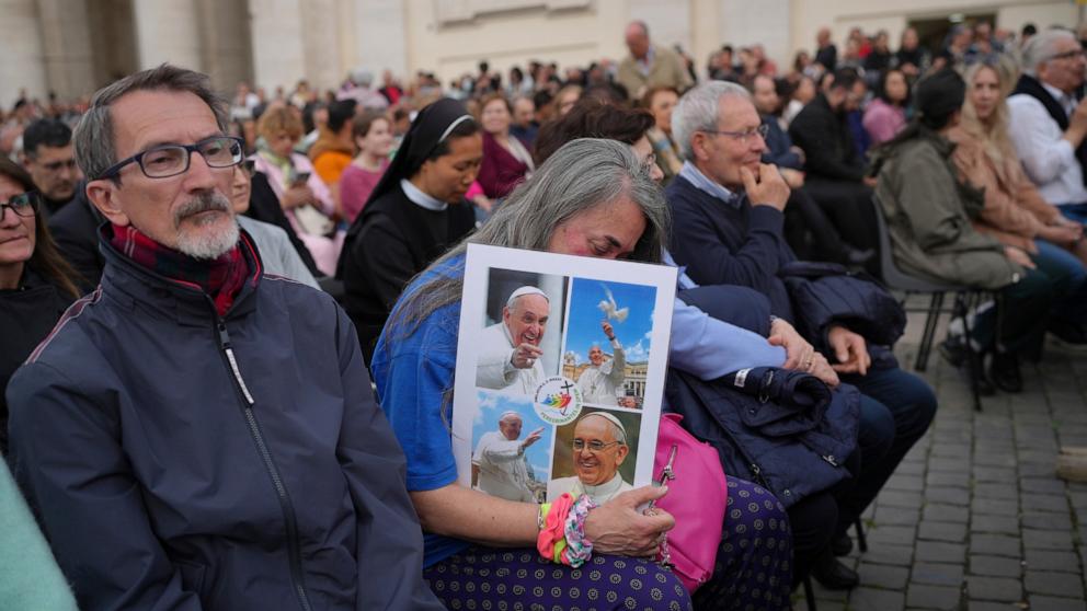 PHOTO: Faithful wait for a rosary prayer for the late Pope Francis, in St. Peter's Square at the Vatican, April 21, 2025. 