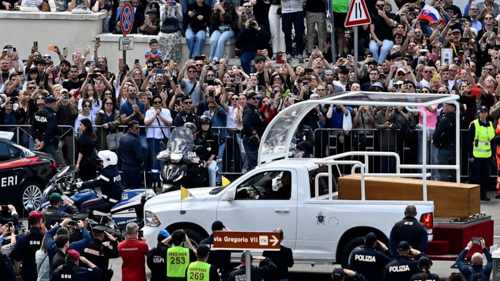 PHOTO: People gather along the road as the coffin of late Pope Francis is transported from St Peter's Basilica to Santa Maria Maggiore Basilica, during the funeral ceremony in Rome, April 26, 2025.