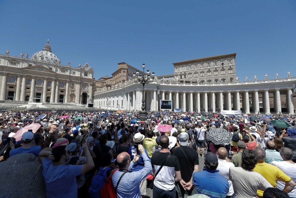 PHOTO: People watch Pope Francis as he recites the Angelus noon prayer from the window of his studio overlooking St. Peter's Square, at the Vatican, June 10, 2018.