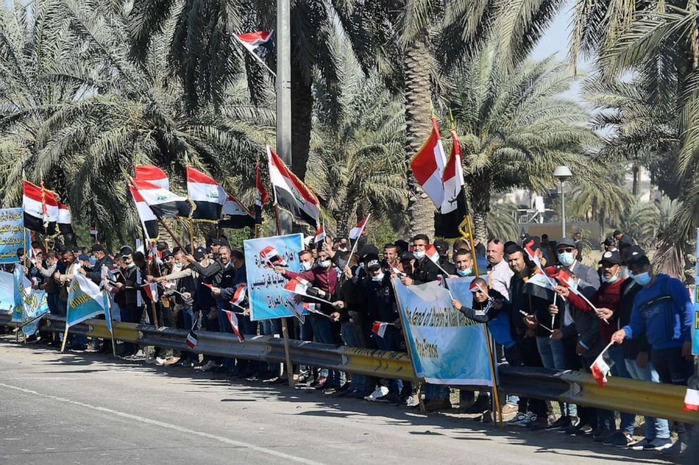 PHOTO: People line a road for the visit of Pope Francis in Baghdad, Iraq on March 5, 2021.