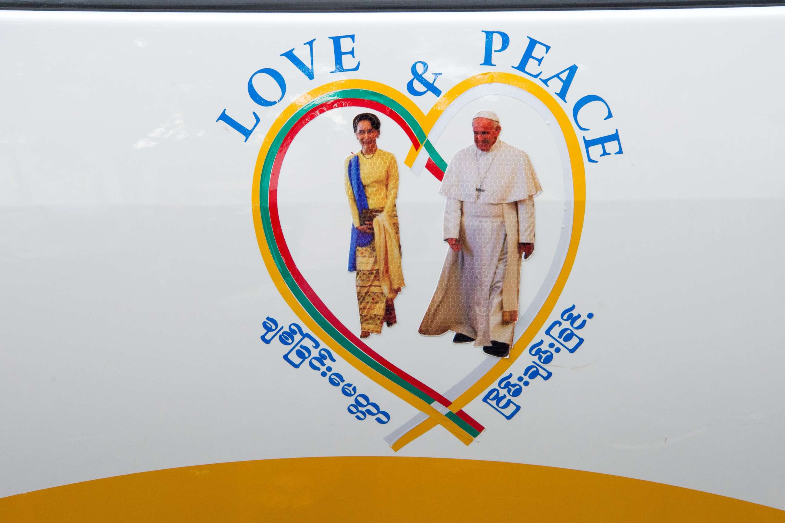 PHOTO: A sticker of Myanmar's State Counselor Aung San Suu Kyi (L) and Pope Francis is displayed on a car in the streets of downtown Yangon, after the pope's arrival in Myanmar for a four-day official visit on Nov. 27, 2017. 
