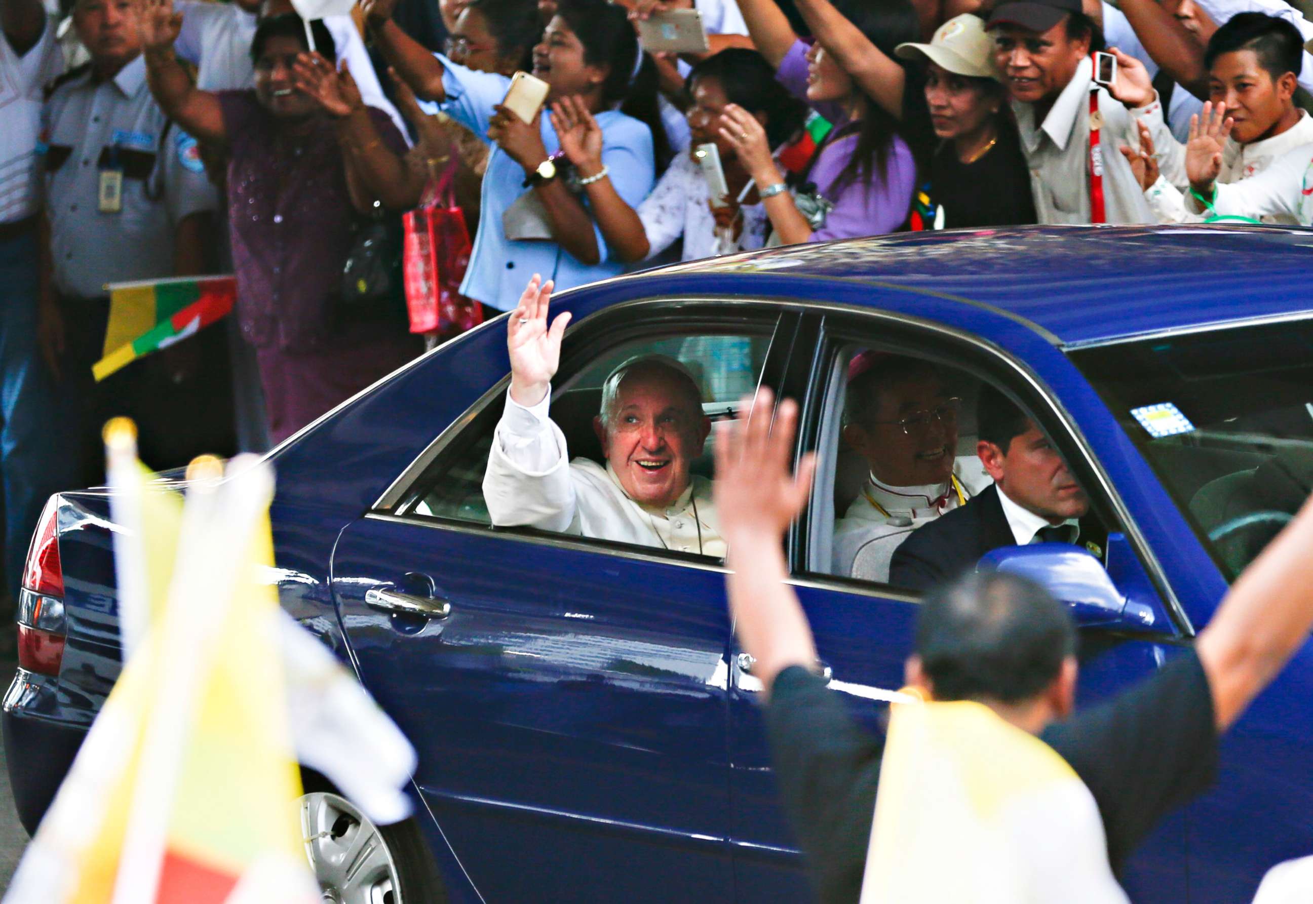 PHOTO: Pope Francis waves as as he is welcomed by the crowd along a road in Yangon, Myanmar, Nov. 27, 2017. 
