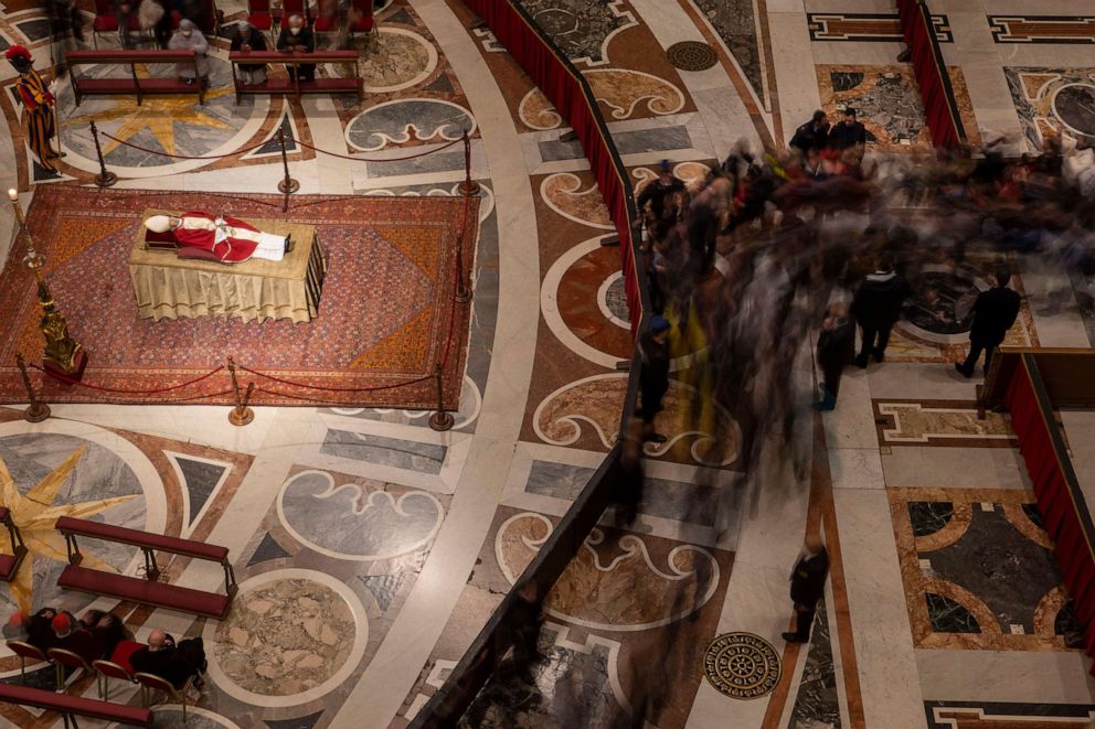 PHOTO: A stream of mourners approach the body of late Pope Emeritus Benedict XVI lying out in state inside St. Peter's Basilica at The Vatican where thousands went to pay their homage, Jan. 3, 2023.
