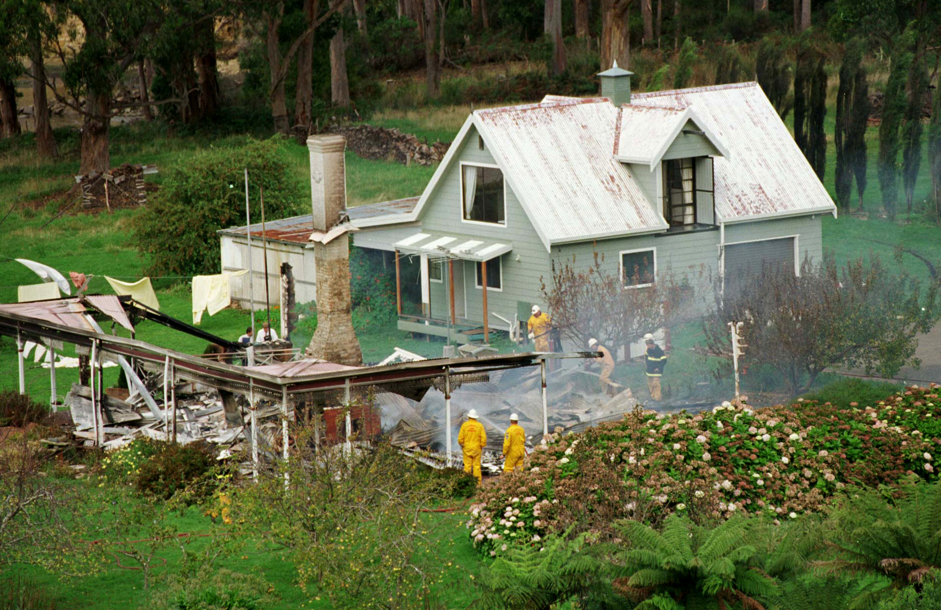 PHOTO: Emergency services personnel search the ruins of the Seascape Guesthouse where gunman Martin Bryant retreated after shooting and killing 35 people during the Port Arthur massacre, April 29, 1996.