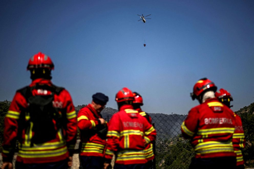 PHOTO: A firefighting helicopter flies over as firefighters prepare to tackle a wildfire in Murca, Portugal, July 20, 2022.