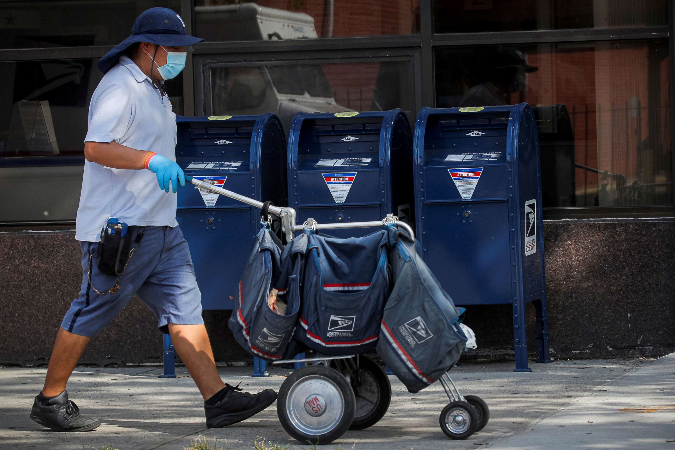 PHOTO: A mail carrier delivers mail in the Brooklyn, New York, Aug. 21, 2020.
