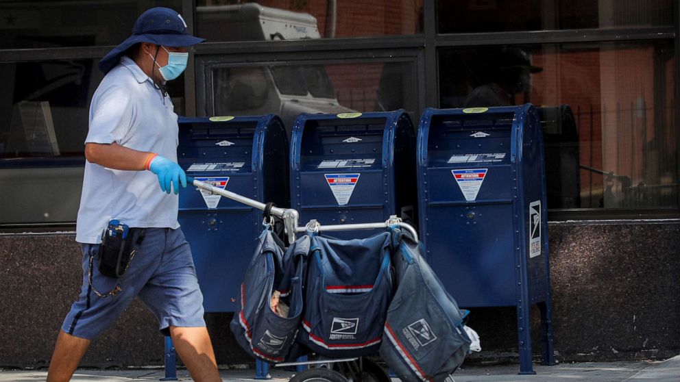 PHOTO: A mail carrier delivers mail in the Brooklyn, New York, Aug. 21, 2020.