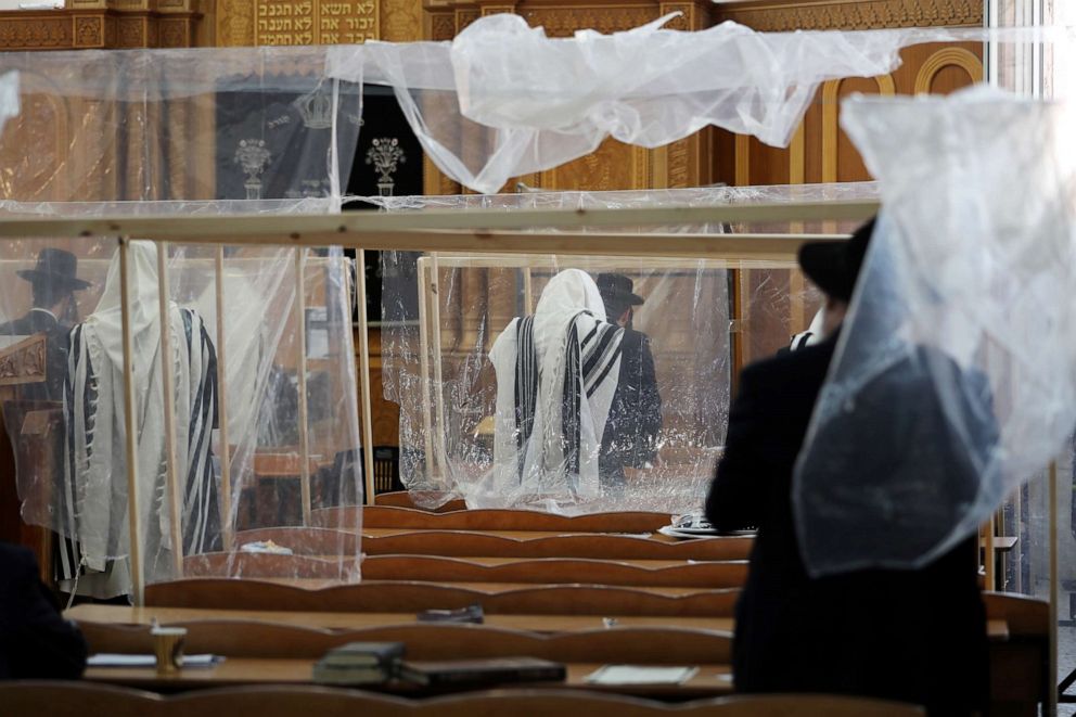 PHOTO: Ultra-Orthodox Jewish men maintain social distancing and cover themselves in prayer shawls during early morning prayers at a synagogue in Jerusalem, Israel, on Sept. 16, 2020, two days before a nationwide lockdown to curb the spread of COVID-19.