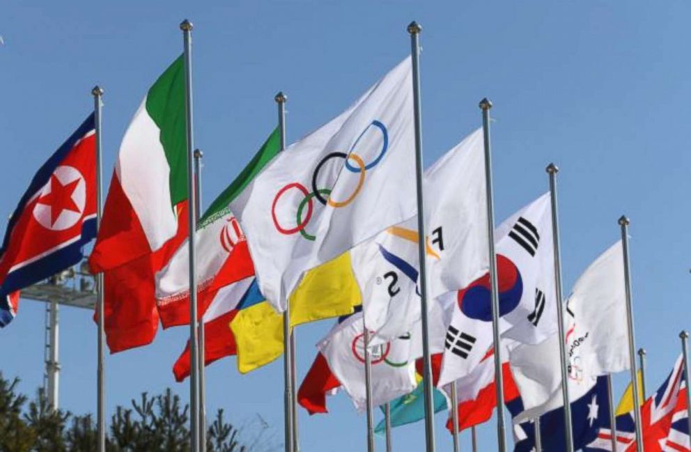 PHOTO:The Olympic flag surrounded by flags from various countries that are competing in the Winter Olympics, wave in the wind in front of the Olympic Stadium in Pyeongchang, South Korea, Feb. 7, 2018. 