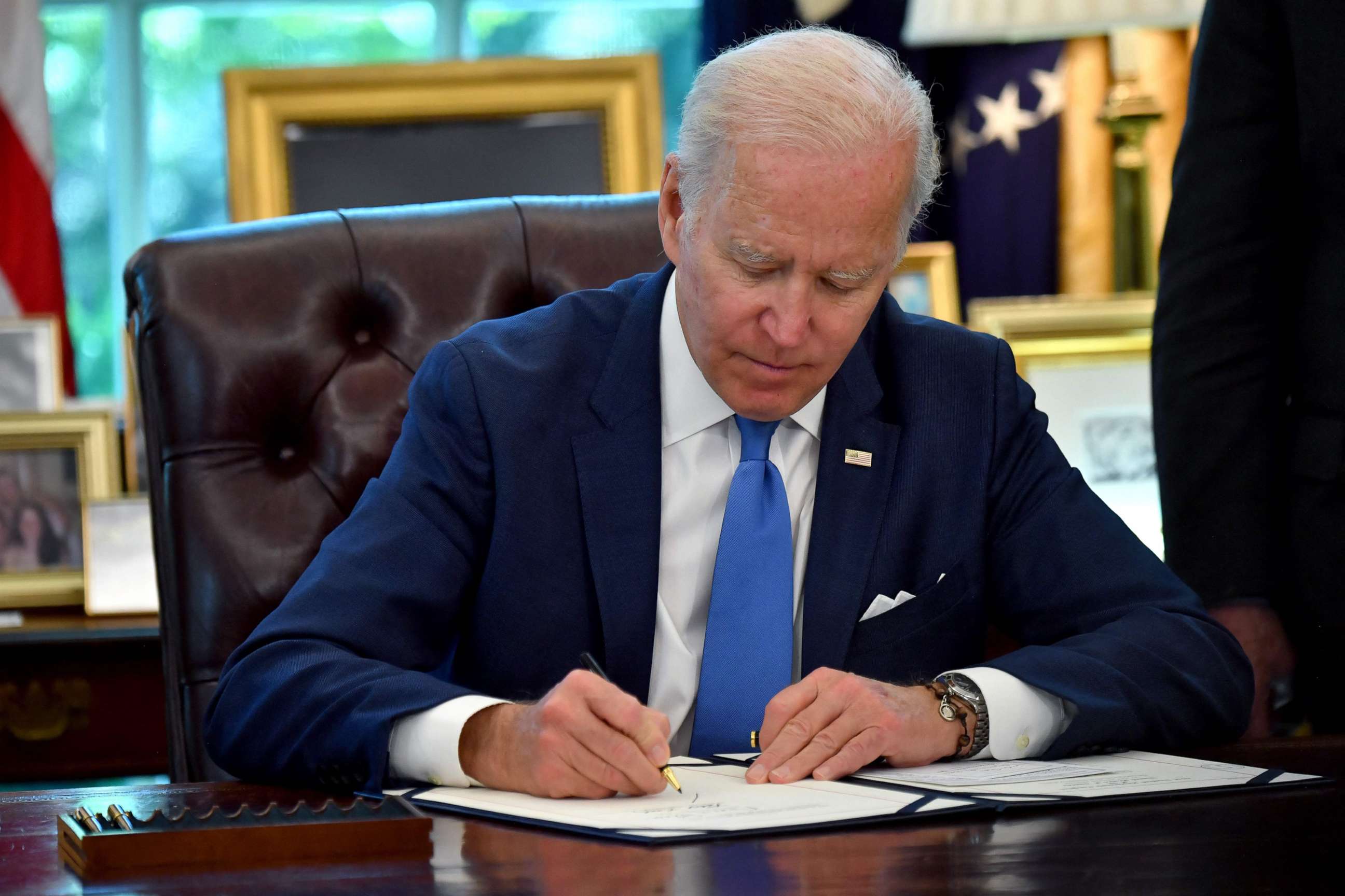 PHOTO: President Joe Biden signs into law the Ukraine Democracy Defense Lend-Lease Act of 2022, in the Oval Office of the White House in Washington, May 9, 2022.