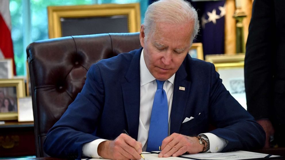 PHOTO: President Joe Biden signs into law the Ukraine Democracy Defense Lend-Lease Act of 2022, in the Oval Office of the White House in Washington, May 9, 2022.