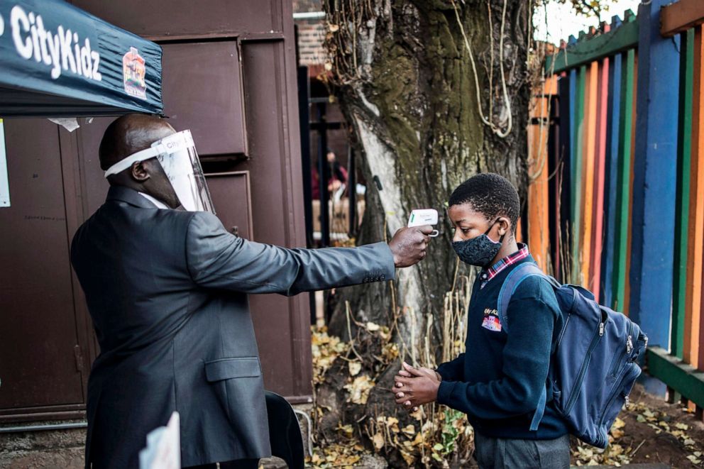 PHOTO: A pupil at the City Kidz Pre & Primary School has his temperature taken as he enters the school premises in the Inner City district of Johannesburg, South Africa, on June 1, 2020.