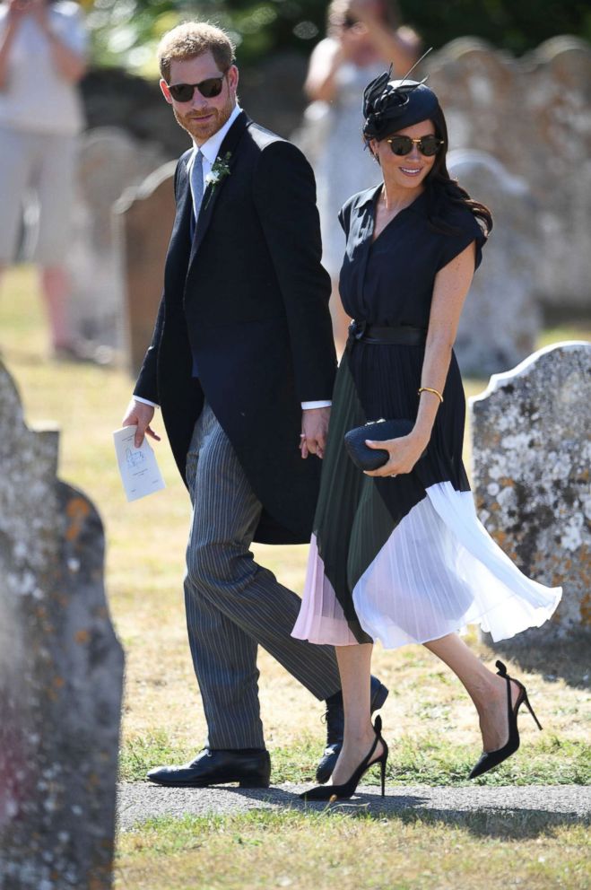 PHOTO: The Duke and Duchess of Sussex walk outside St. Mary the Virgin Church in Frensham, Surrey, after attending the wedding of Charlie van Straubenzee and Daisy Jenks, Aug. 4, 2018.