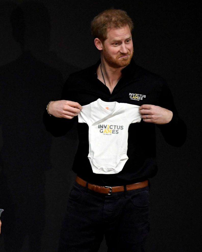 PHOTO: Britain's Prince Harry holds a onesie next to Princess Margriet of the Netherlands, during the official launch of the one year countdown to the Invictus Games The Hague 2020, in The Hague, Netherlands, May 9, 2019.