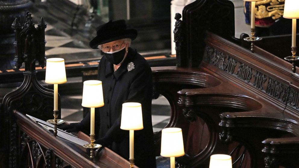 PHOTO: Britain's Queen Elizabeth II takes her seat alone in St. George's Chapel during the funeral of Prince Philip, the man who had been by her side for 73 years, at Windsor Castle, Windsor, England, April 17, 2021.
