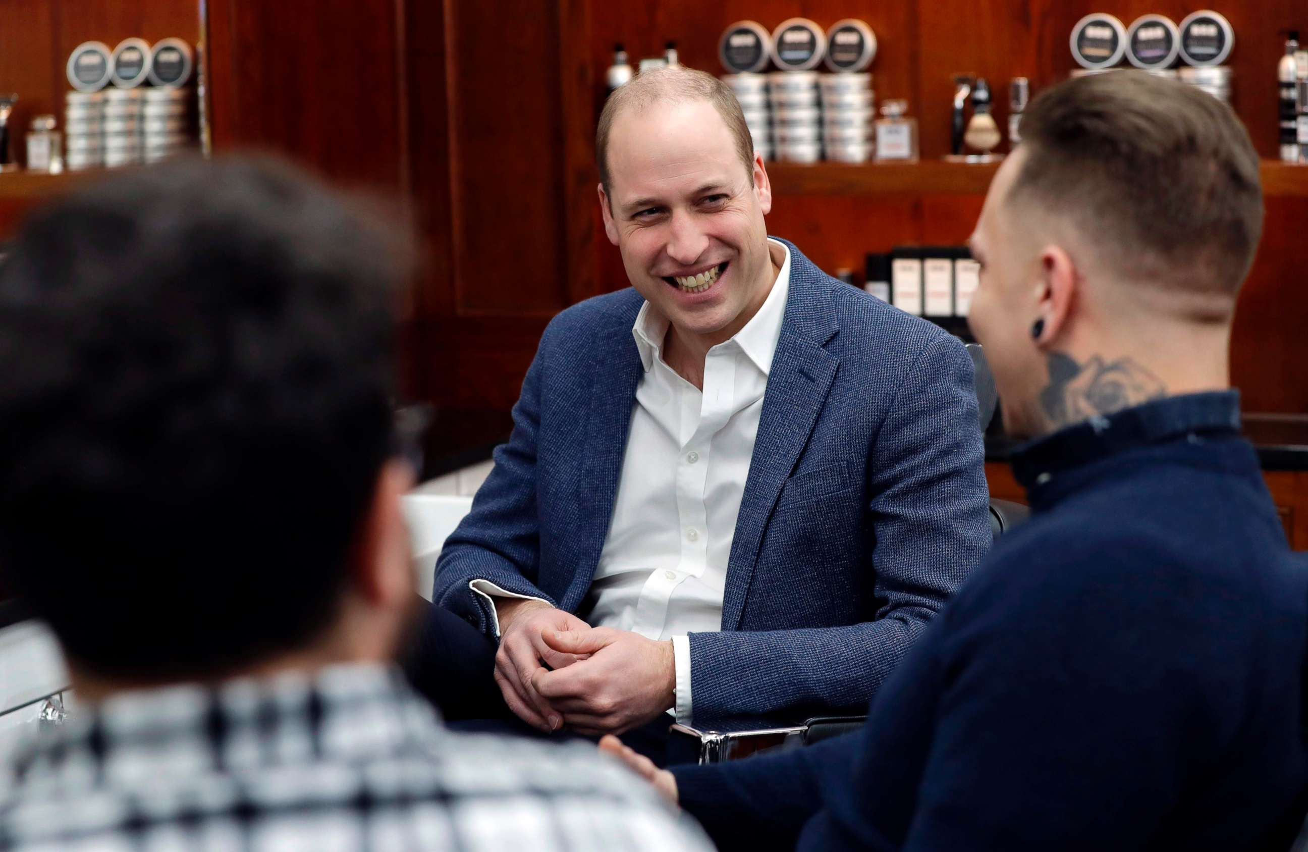 PHOTO: Prince William, Duke of Cambridge, speaks speaks to Dean Hamilton (R), and Paul Richardson (L) during a visit to Pall Mall Barbers in London, Feb. 14, 2019. 