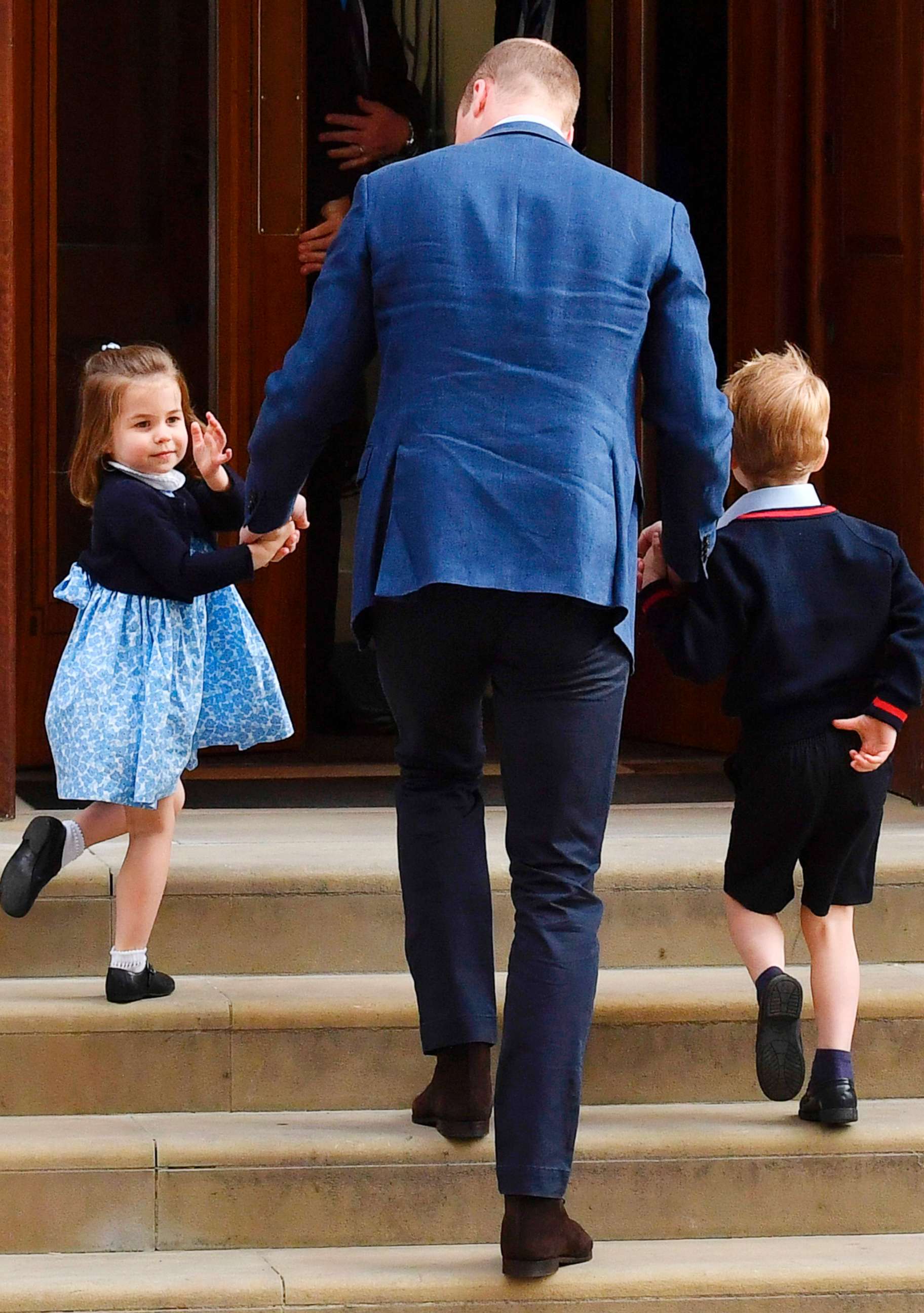 PHOTO:Princess Charlotte of Cambridge turns to wave at the media a by her father Britain's Prince William, Duke of Cambridge, at the Lindo Wing of St Mary's Hospital in central London, April 23, 2018.