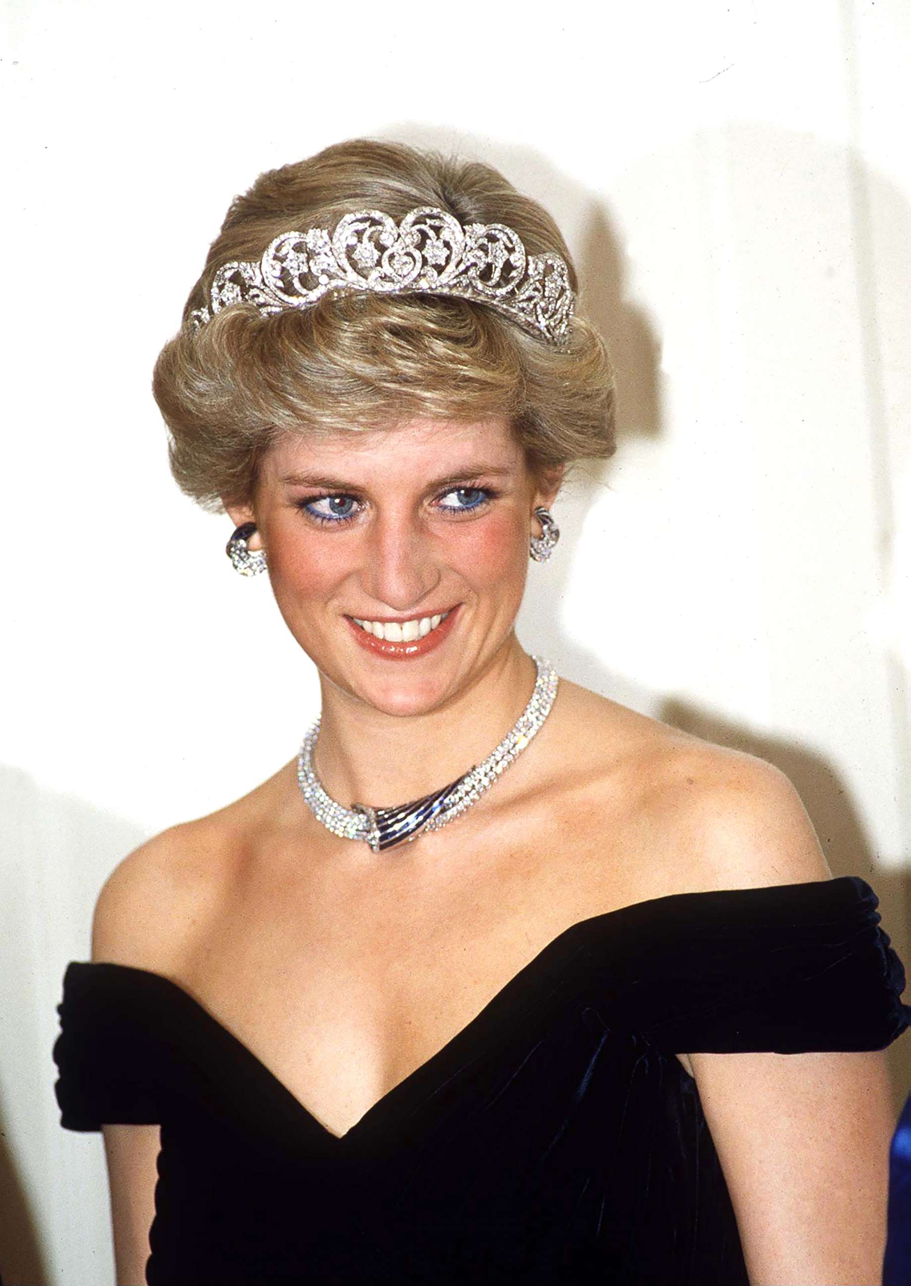PHOTO: Princess Diana poses in Bonn, Germany, wearing sapphire and diamond jewels which were a gift from the Sultan of Oman (the Tiara is her own) with a dress designed by Victor Edelstein. 