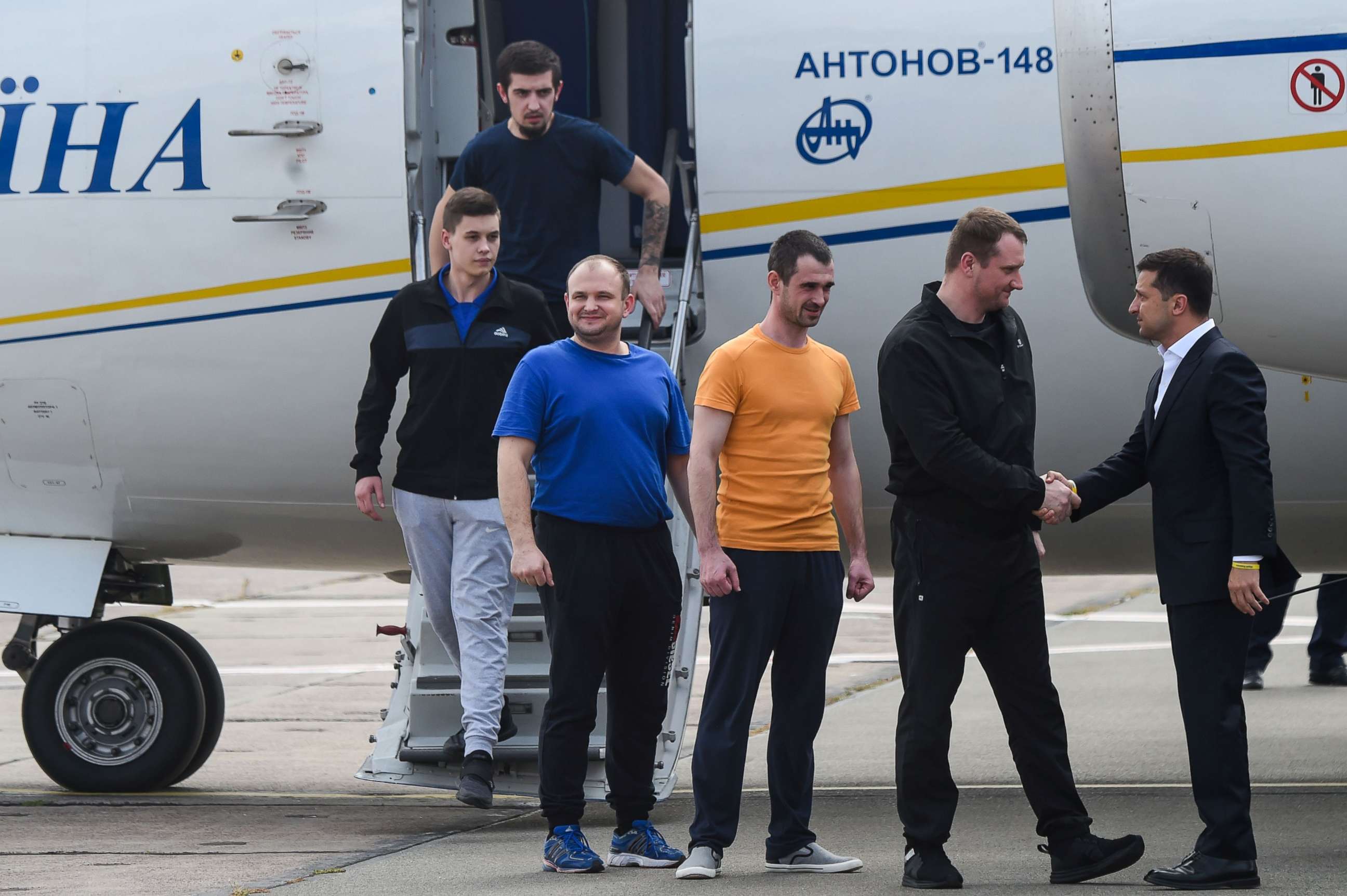 PHOTO: Ukraine's President Volodymyr Zelensky welcomes former prisoners as they disembark from a plane on September 7, 2019 at Boryspil international airport in Kiev after a long-awaited exchange of prisoners between Moscow and Kiev.