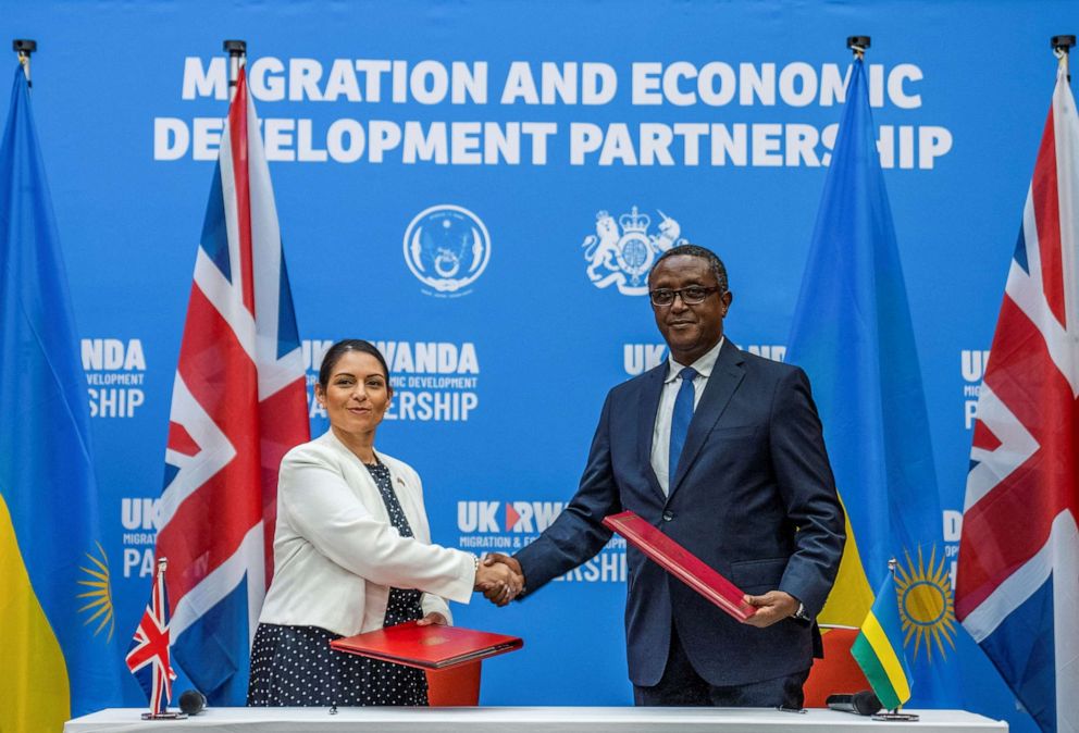 PHOTO: British Home Secretary Priti Patel shakes hands with Rwandan Foreign Minister Vincent Birutaare after signing the partnership agreement at a joint news conference in Kigali, Rwanda, April 14, 2022.