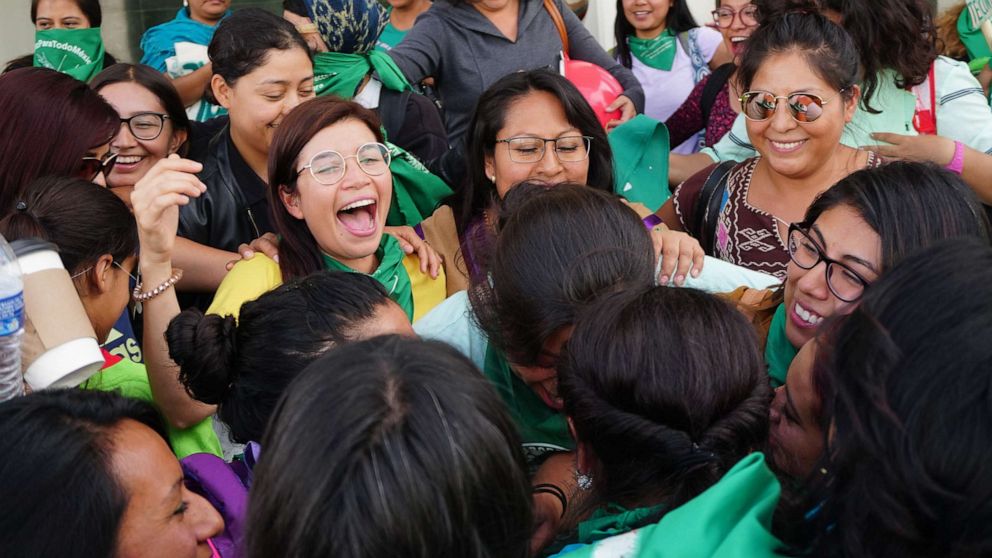 PHOTO: Feminists of the so-called 'Green Tide' celebrate and wave handkerchiefs after the Oaxaca State Congress decriminalized abortion by approving an opinion authorizing the legal termination of pregnancy before 12 weeks gestation, in Oaxaca, Mexico.