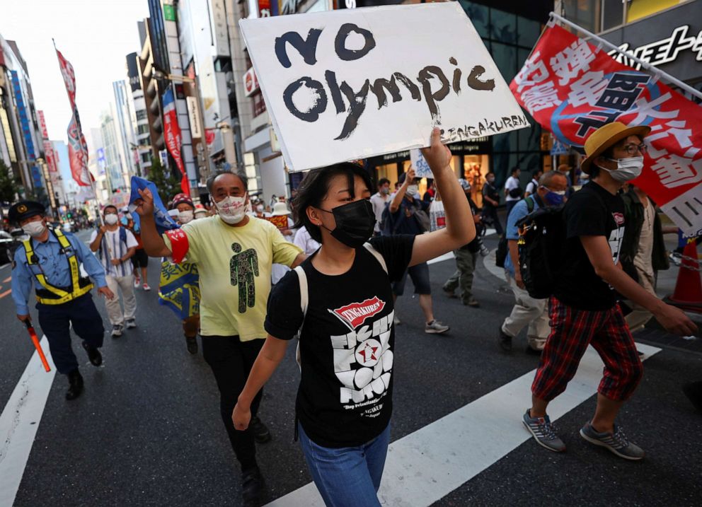 PHOTO: Anti-Olympics group's members wearing protective face masks display banners during their protest march, amid the coronavirus disease (COVID-19) pandemic, at Shinjuku district in Tokyo, Japan on Aug. 1, 2021.