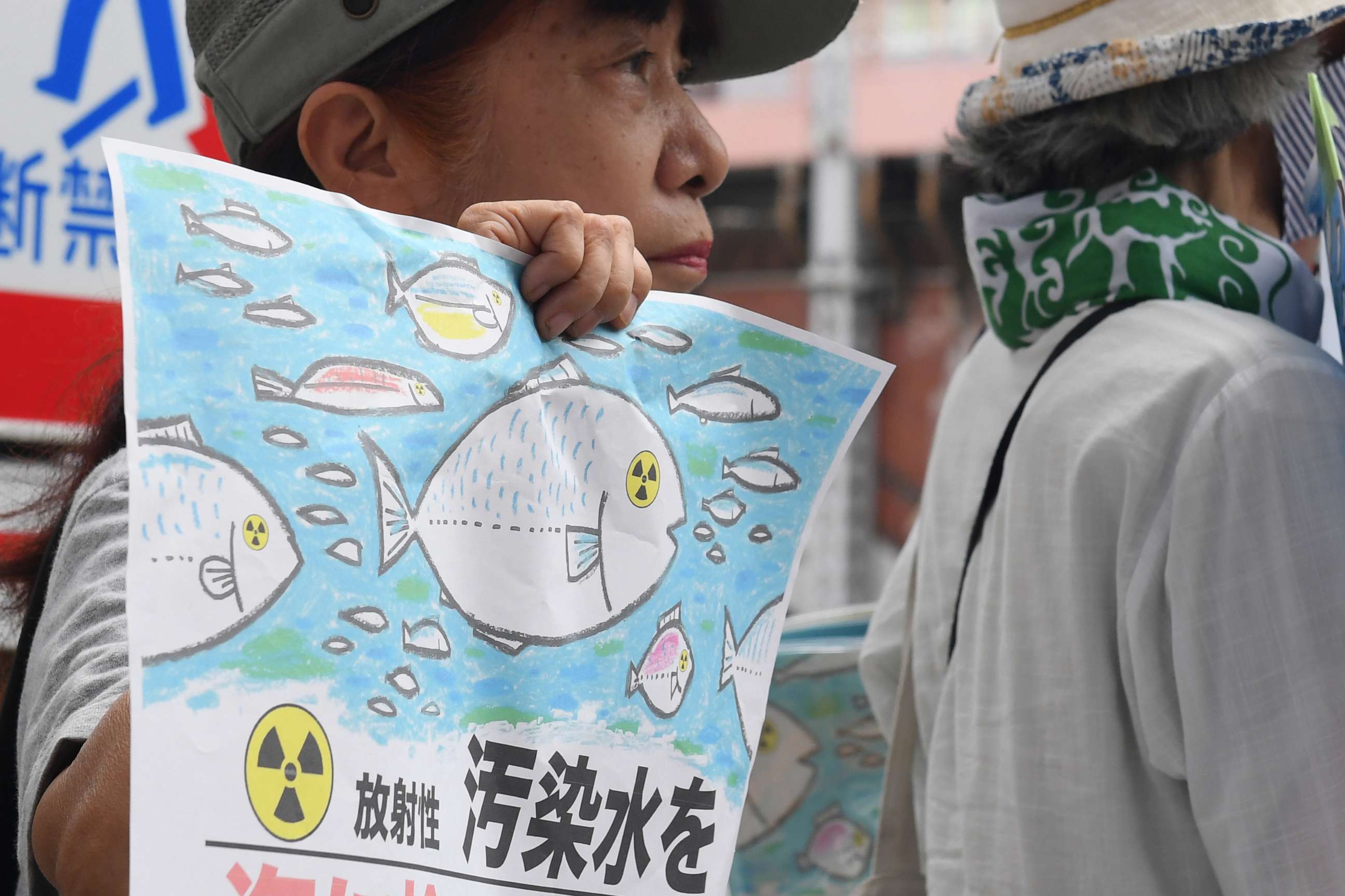 PHOTO: A protester holds a sign which partly reads "Do not discharge the wastewater into the sea" during a rally in front of TEPCO headquarters, Thursday, Aug. 24, 2023, in Tokyo.