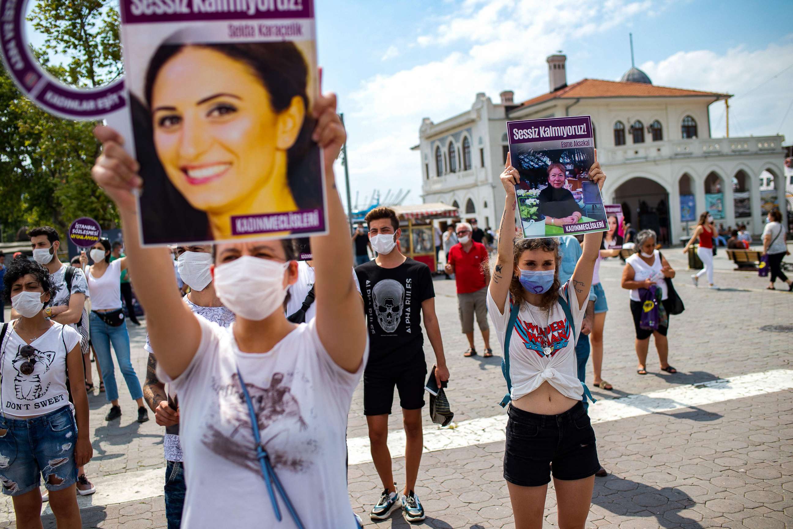 PHOTO: Demonstrators wearing protective face masks, hold portraits of women and placards reading 'we are not quiet', during a protest called by KCDP for protection of the family and prevention of violence against women, in Istanbul, July 19, 2020. 