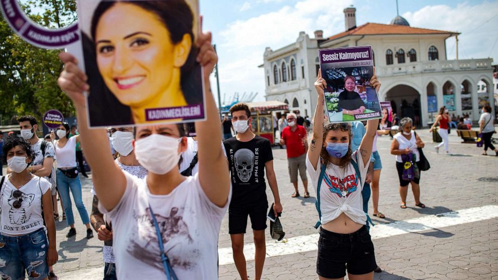 PHOTO: Demonstrators wearing protective face masks, hold portraits of women and placards reading 'we are not quiet', during a protest called by KCDP for protection of the family and prevention of violence against women, in Istanbul, July 19, 2020. 