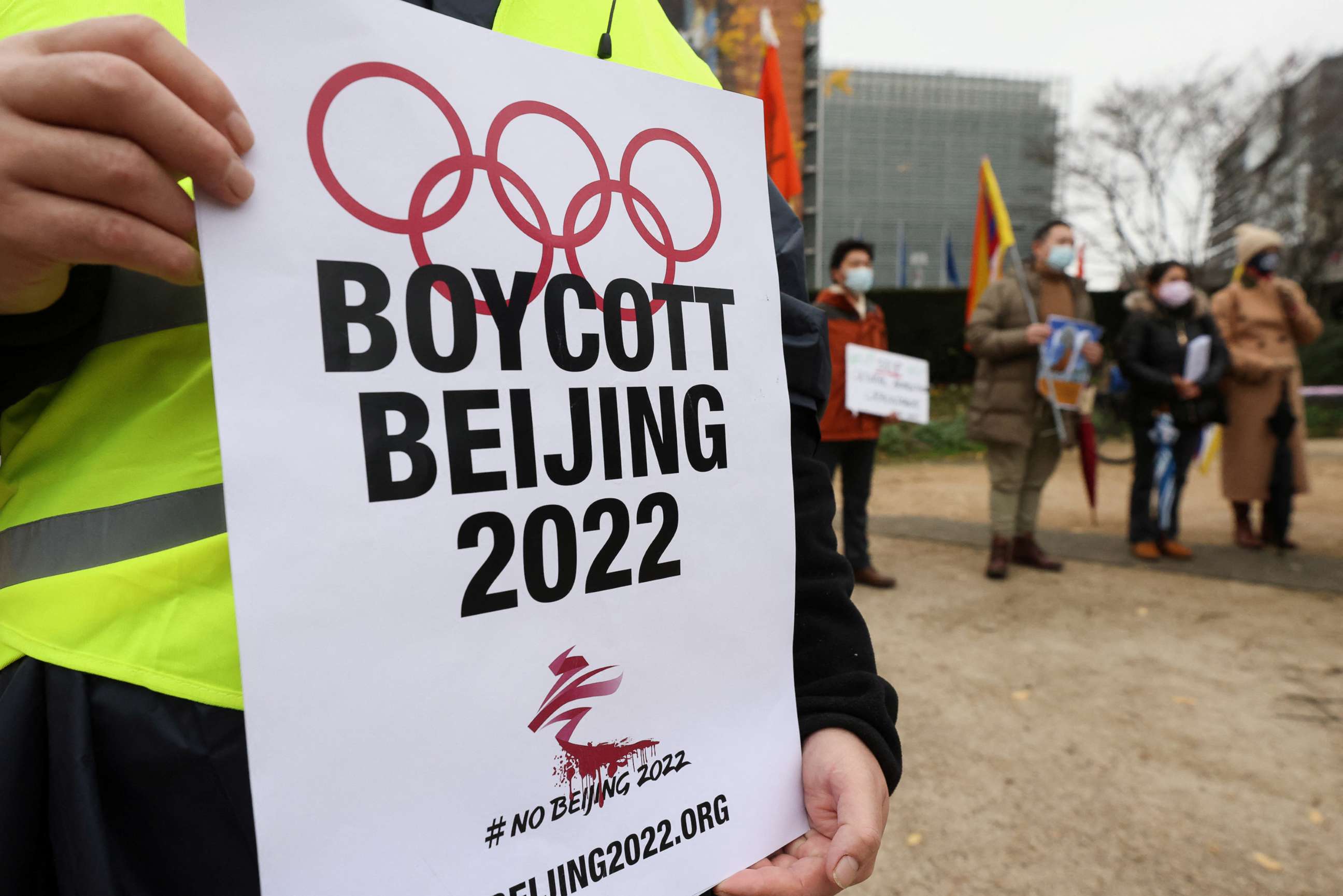 PHOTO: A man holds a placard as he takes part in a protest calling for a boycott of the 2022 Winter Olympics in Beijing, in front of the European Union headquarters in Brussels, Belgium, Jan. 4, 2022. 