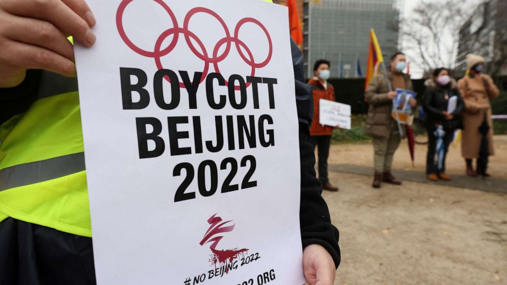 PHOTO: A man holds a placard as he takes part in a protest calling for a boycott of the 2022 Winter Olympics in Beijing, in front of the European Union headquarters in Brussels, Belgium, Jan. 4, 2022. 