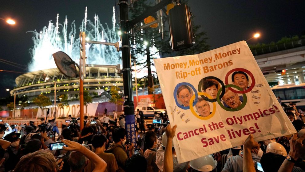 PHOTO: People stage a protest before the National Stadium during the opening ceremony of the Tokyo 2020 Games in Tokyo, Japan, 23 July 2021.