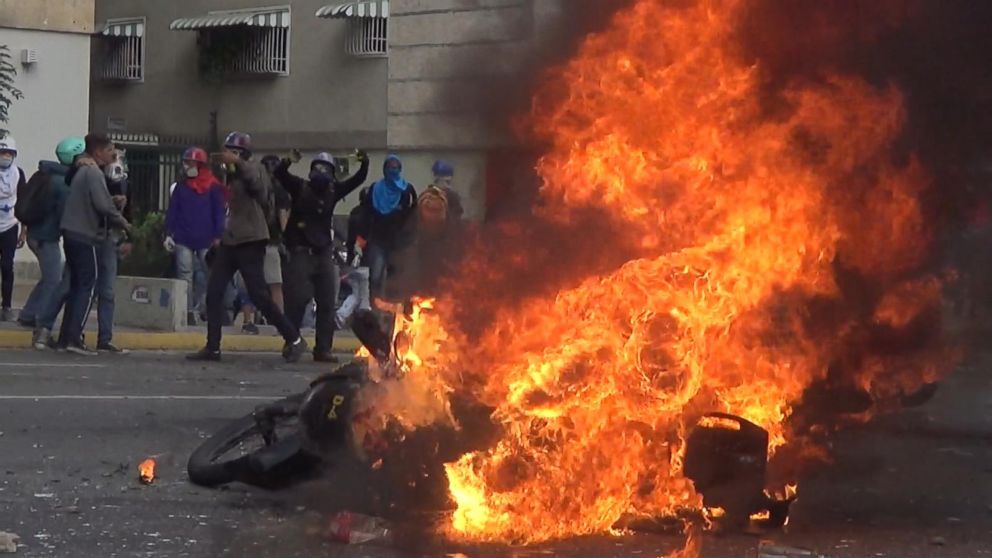 PHOTO: A police motorcycle burns in the streets of Caracas, Venezuela.