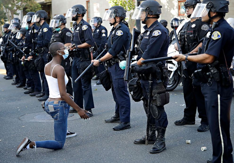 PHOTO: A masked protester kneels before San Jose police, May 29, 2020, in San Jose, Calif., in response to the death of George Floyd in police custody on Memorial Day in Minneapolis.