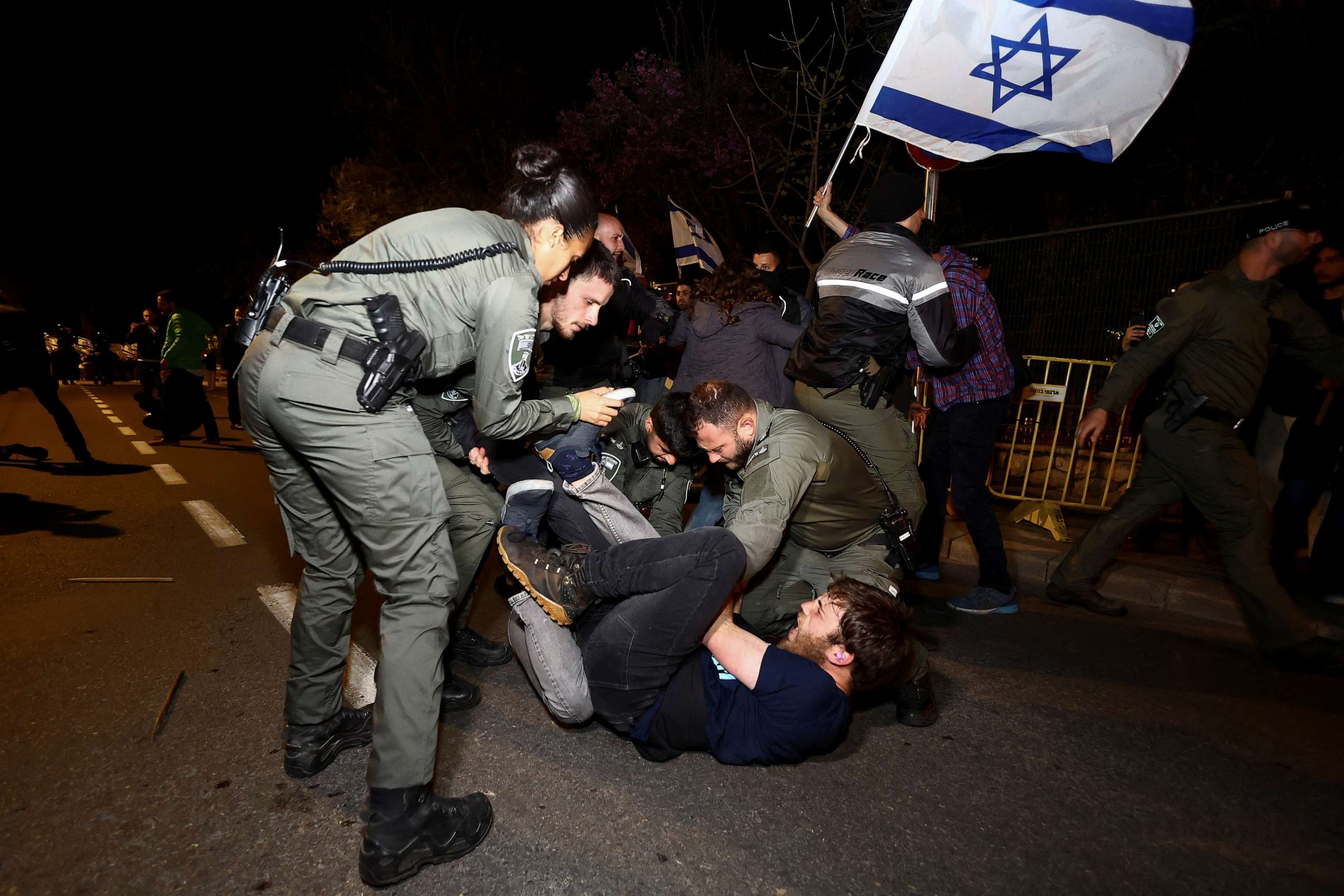 PHOTO: Police officers detain a protester during a demonstration after Israeli Prime Minister Benjamin Netanyahu dismissed the defense minister, in Jerusalem, March 26, 2023.