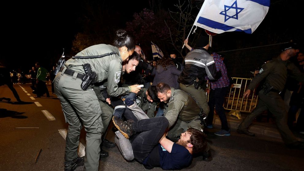 PHOTO: Police officers detain a protester during a demonstration after Israeli Prime Minister Benjamin Netanyahu dismissed the defense minister, in Jerusalem, March 26, 2023.