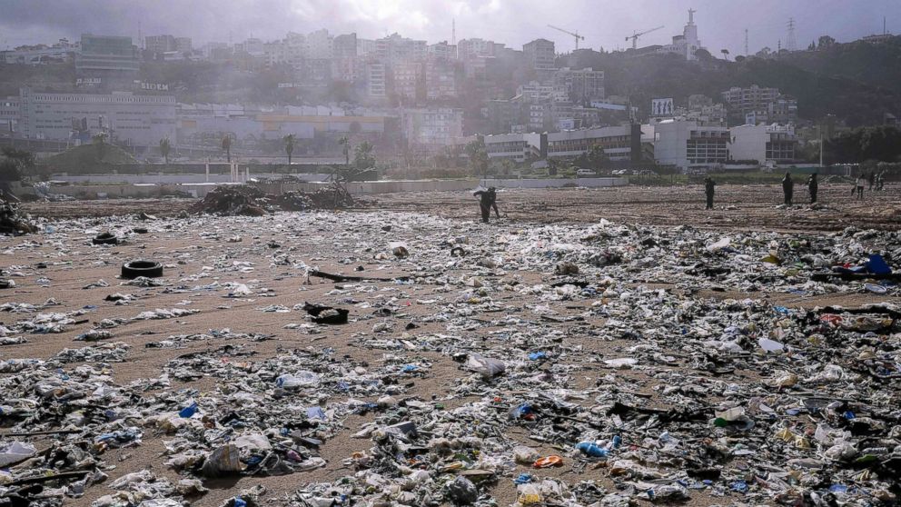 Workers clean garbage off of the beach of the coastal town of Zouk Mosbeh, north of Beirut, Lebanon, on Jan. 23, 2018.