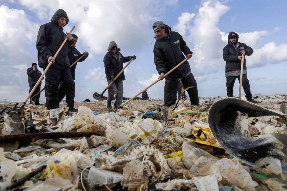 PHOTO: Workers clean the beach of the coastal town of Zouk Mosbeh, north of Beirut, on Jan. 23, 2018, after garbage washed ashore in a storm.
