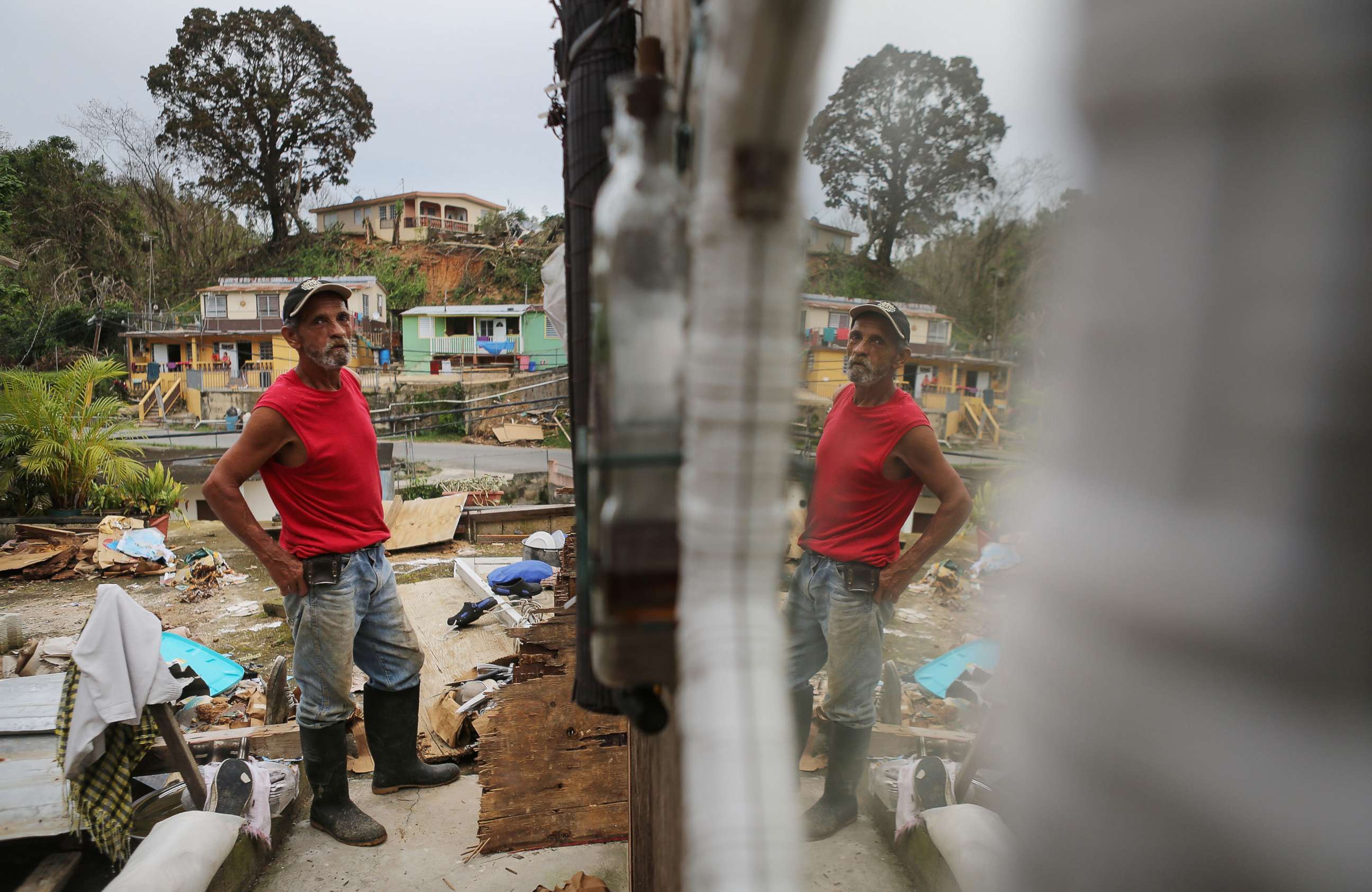 PHOTO: Francisco Zamoro, 69, poses in his former living room, reflected in a mirror still hanging on the wall, three weeks after Hurricane Maria hit the island, Oct. 12, 2017 in Jayuya, Puerto Rico.