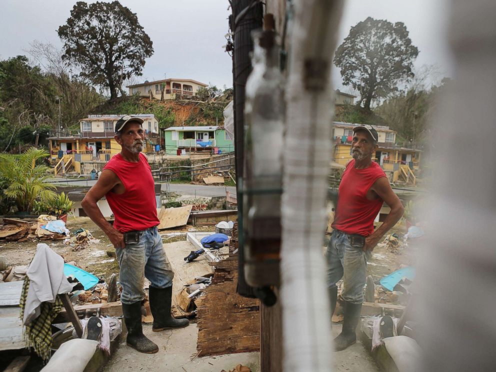 PHOTO: Francisco Zamoro, 69, poses in his former living room, reflected in a mirror still hanging on the wall, three weeks after Hurricane Maria hit the island, Oct. 12, 2017 in Jayuya, Puerto Rico.
