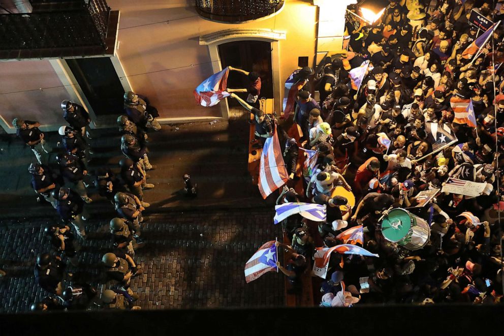 PHOTO: Protesters demonstrate against Ricardo Rossello, the governor of Puerto Rico, near police that are manning a barricade set up along a street leading to the governor's mansion on Monday, July 22, 2019, in Old San Juan, Puerto Rico.